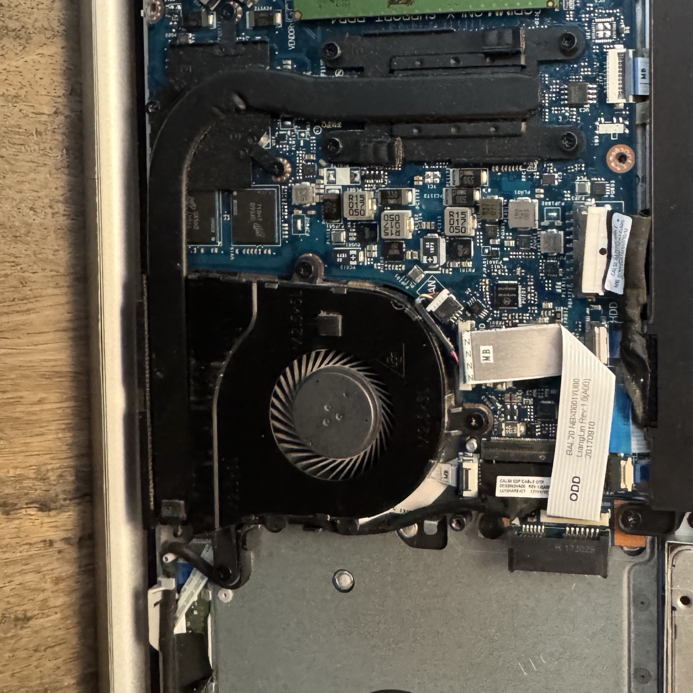 Open laptop showing SSD, memory, battery, and internal storage components