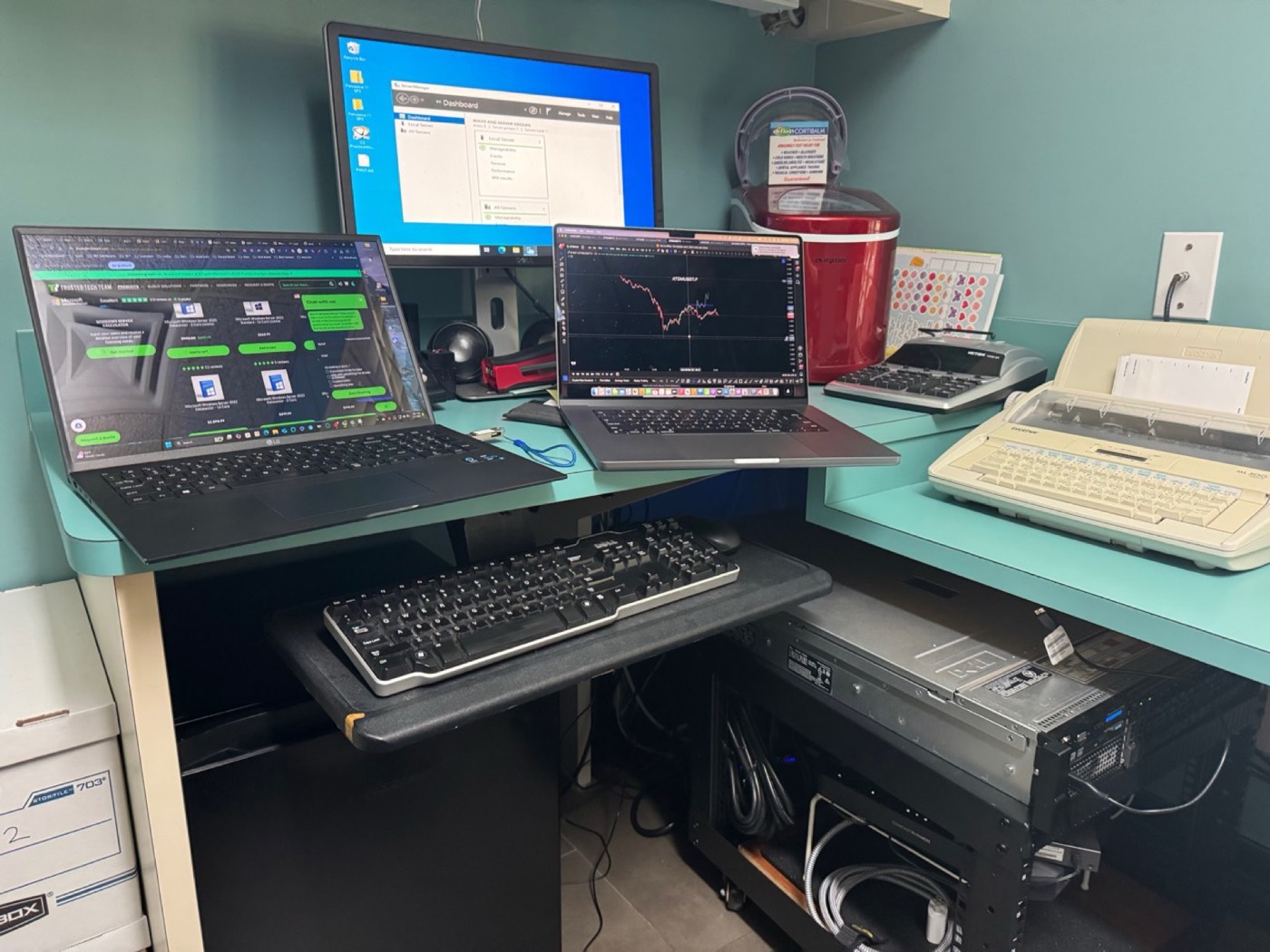 KingsPark IT repair workbench with laptops, monitor, and diagnostic equipment